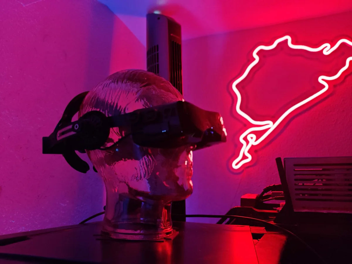 A clear-shell Beyond 2 on a translucent skull bust beside a neon Nurburgring outline