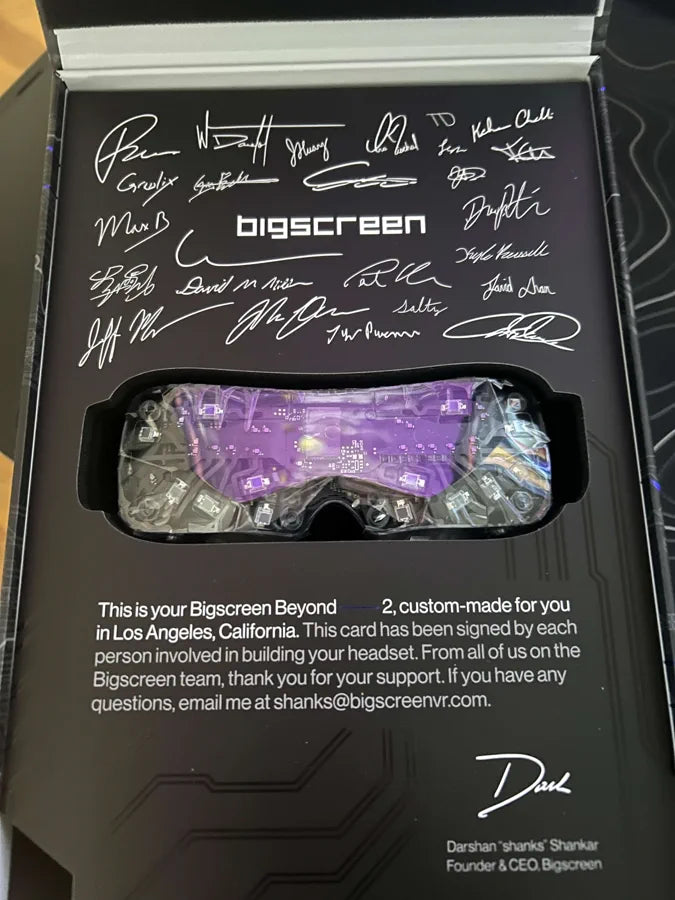 An opened Beyond 2 box showing the card signed by the team that built it