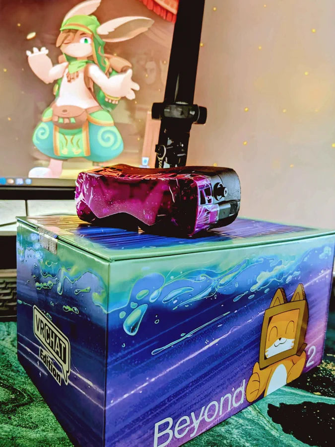 A magenta VRChat Edition Beyond 2 resting on its illustrated box