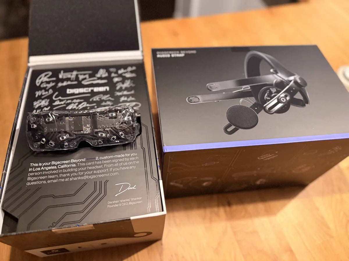 A Beyond 2 box beside an Audio Strap box on a wooden table