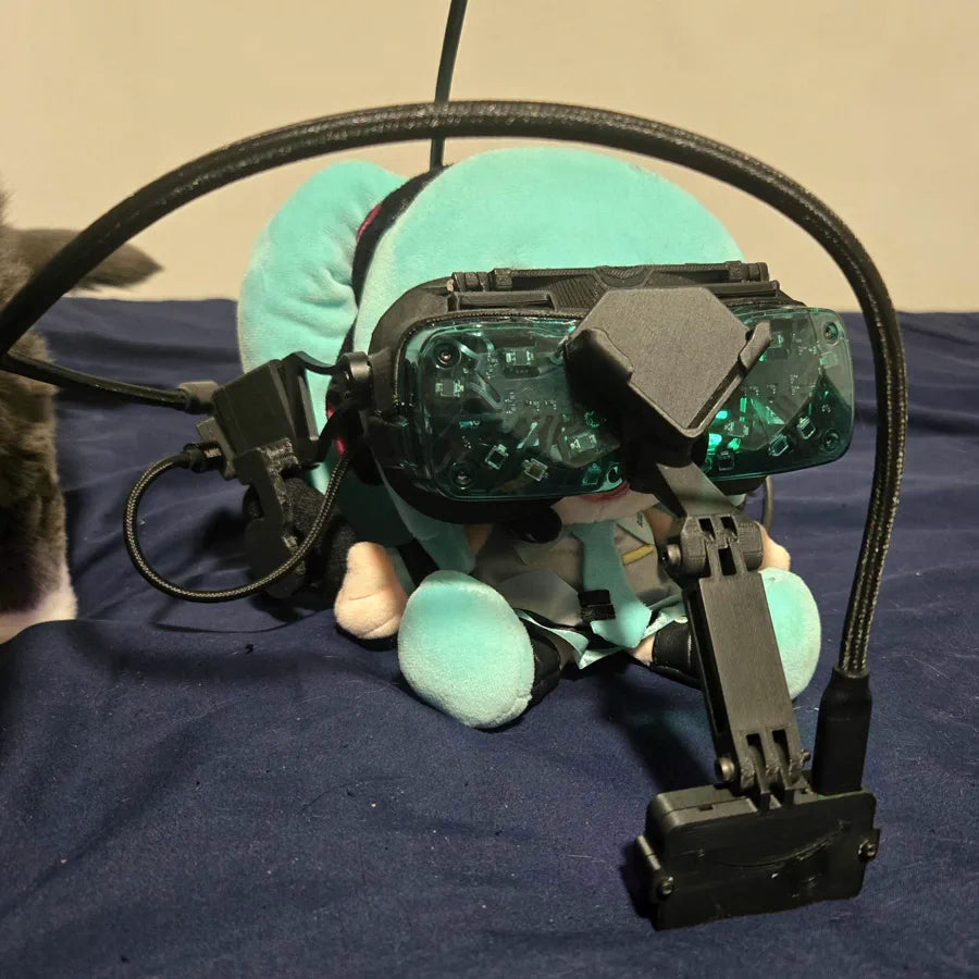A green-shell Beyond 2 resting on a plush toy beside a cat