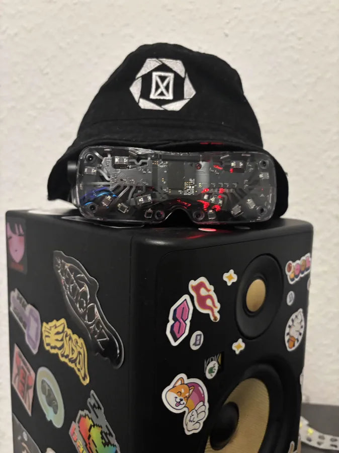A clear Beyond 2 resting on a studio monitor under a beanie
